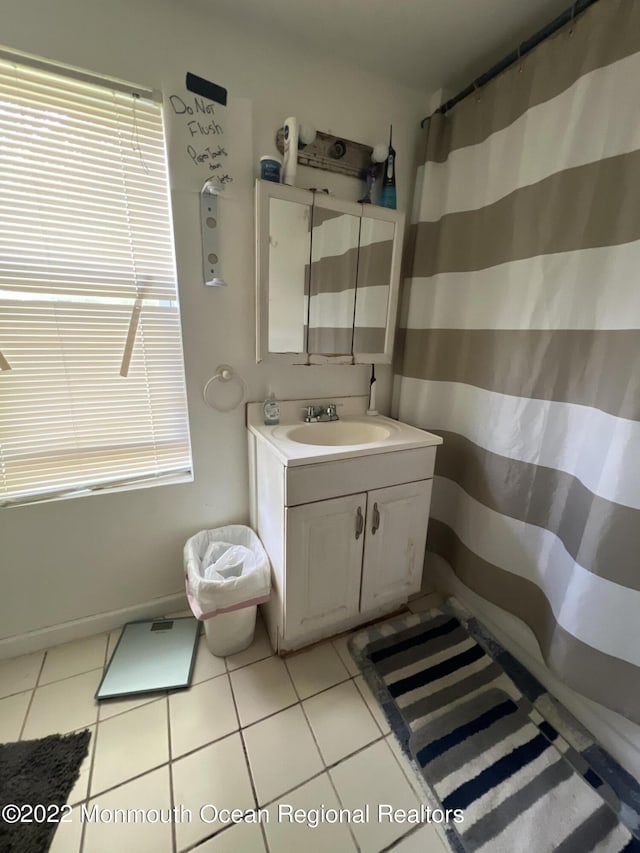 bathroom with tile patterned flooring and vanity