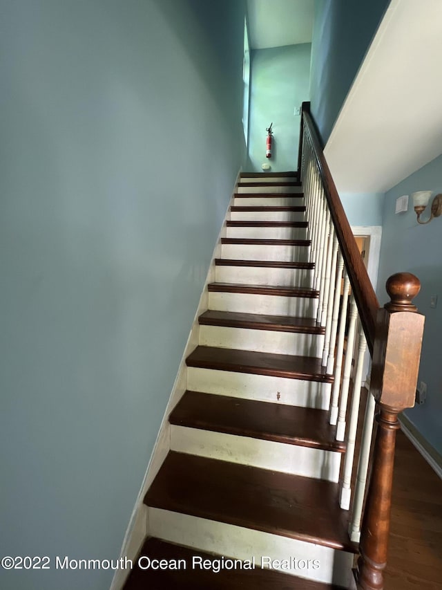 staircase with hardwood / wood-style flooring