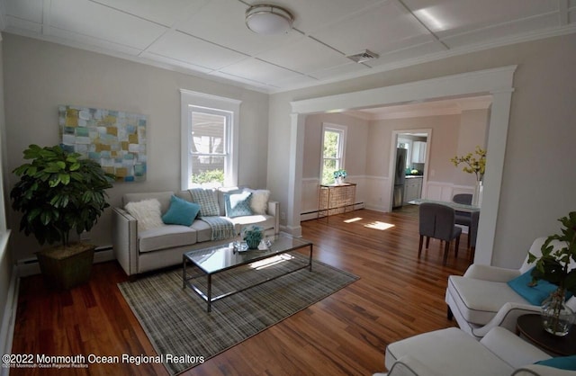 living room featuring a baseboard radiator and dark wood-type flooring