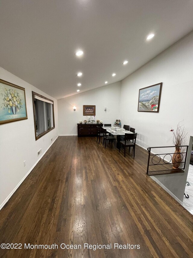 interior space featuring dark hardwood / wood-style flooring and vaulted ceiling