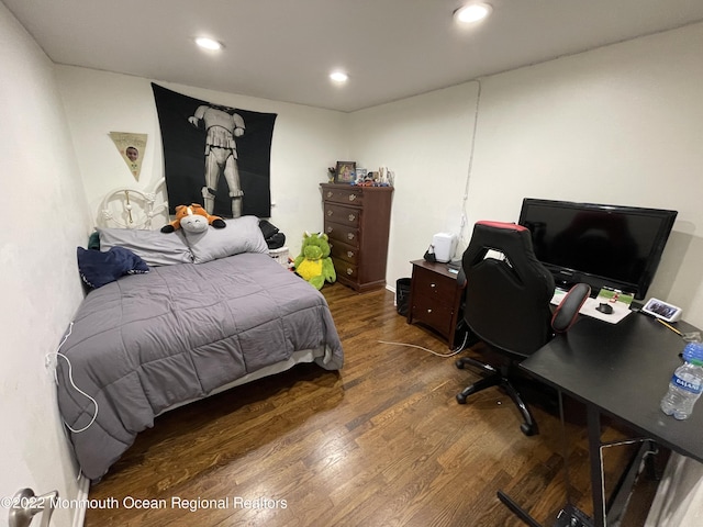 bedroom with dark hardwood / wood-style flooring