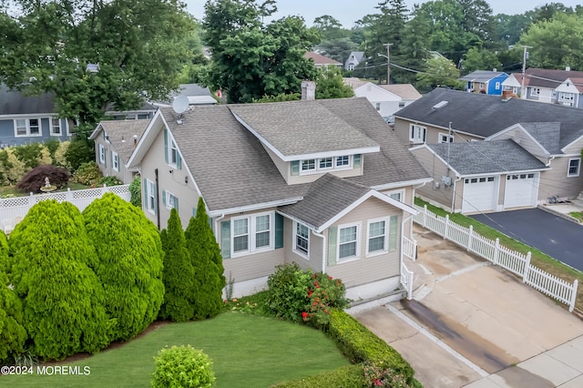 exterior space with a garage and a front lawn