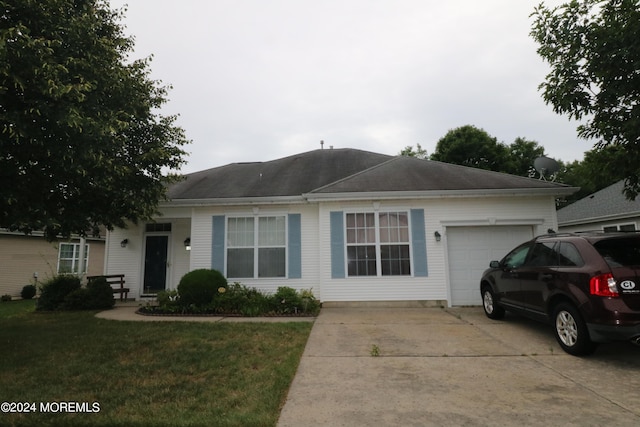 ranch-style home featuring a garage and a front yard