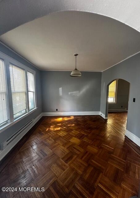 unfurnished room with lofted ceiling and dark parquet floors