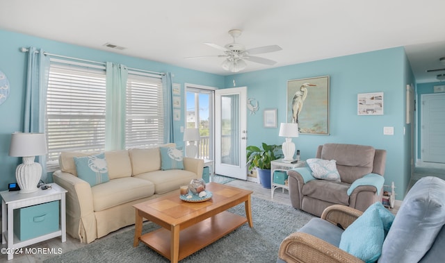 living room featuring light hardwood / wood-style flooring and ceiling fan