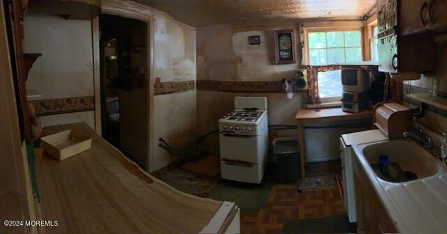 kitchen featuring sink and white gas range