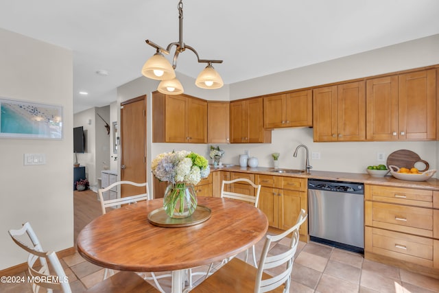 kitchen with sink, dishwasher, light hardwood / wood-style flooring, and hanging light fixtures