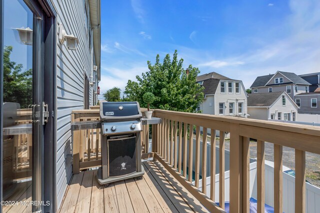 wooden terrace with area for grilling