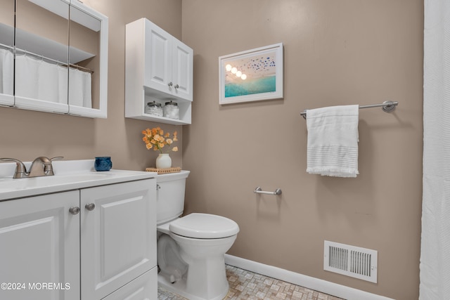 bathroom featuring vanity, toilet, and tile patterned floors