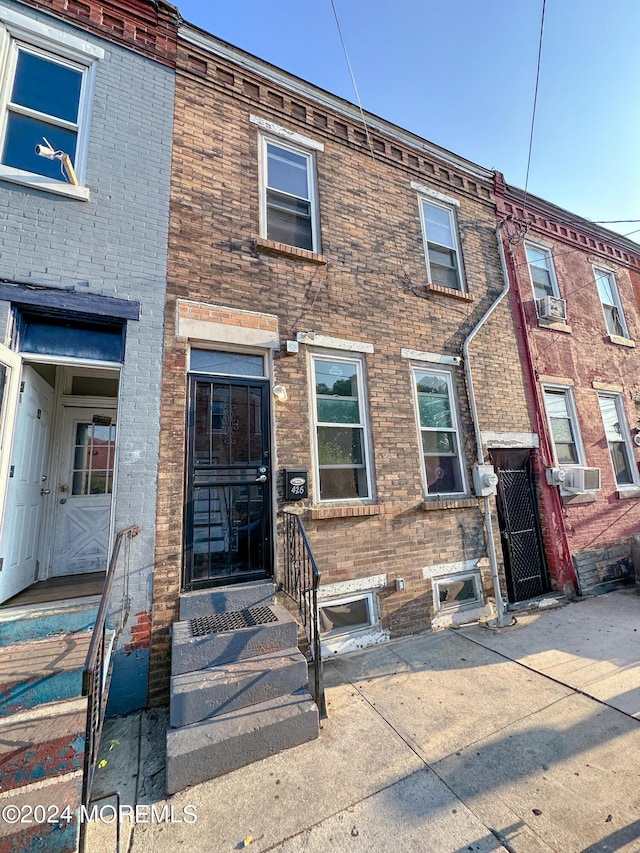 multi unit property featuring cooling unit and brick siding