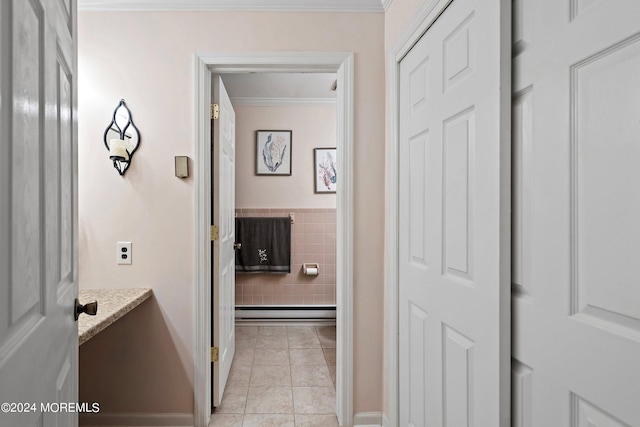 hallway featuring light tile patterned floors and ornamental molding