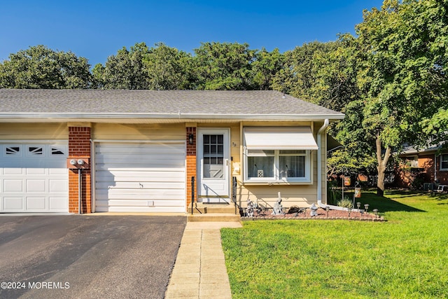 5B Betsy Ross Ln, Whiting, NJ 08759 - view of front of home with a front lawn, a shingled roof, brick siding, and aphalt driveway