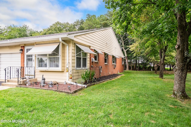 view of side of home with a yard