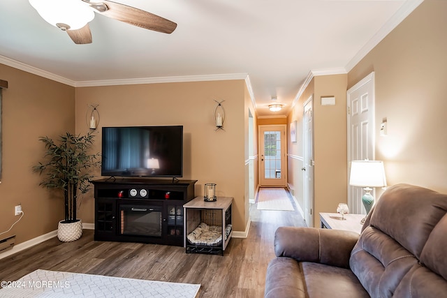 living room with crown molding, ceiling fan, and wood-type flooring