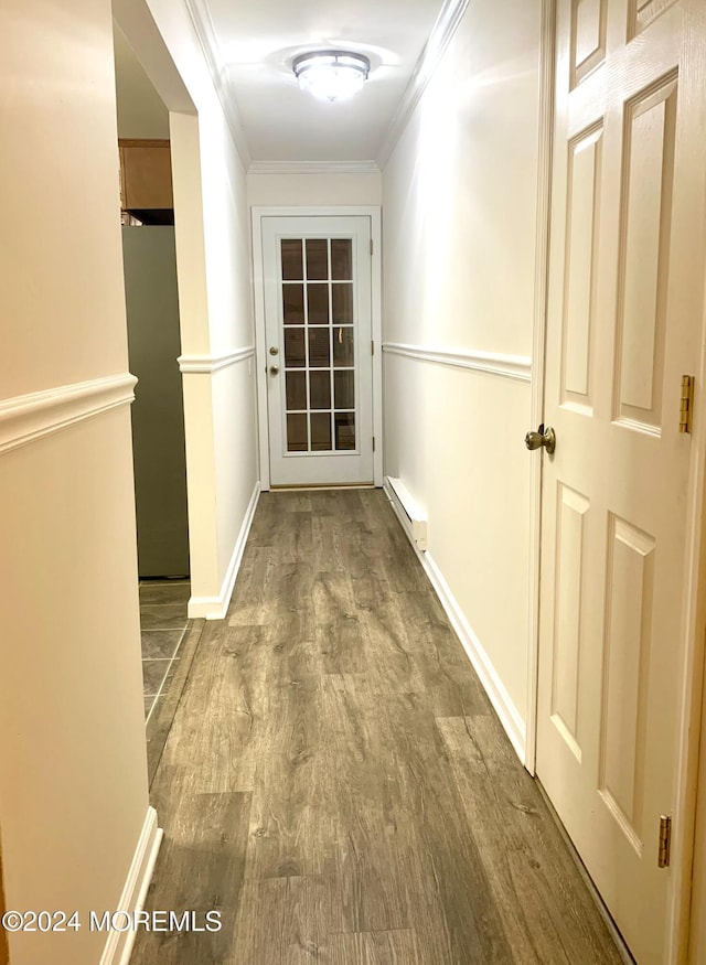 hall featuring baseboard heating, hardwood / wood-style floors, and ornamental molding