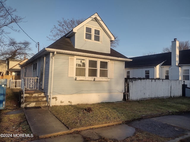 view of side of home featuring fence