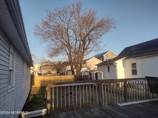 wooden deck with a fenced backyard