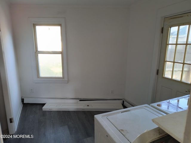 interior space with dark wood-type flooring, washing machine and clothes dryer, and baseboards