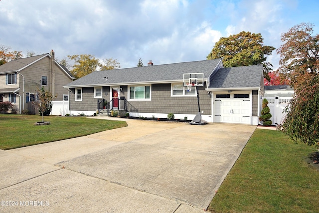 ranch-style house featuring a front yard and a garage