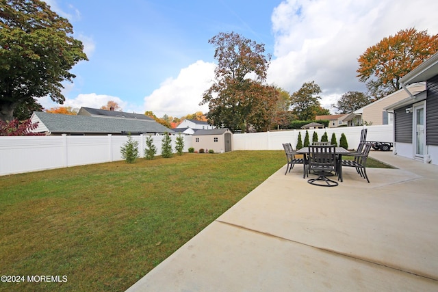 view of yard featuring a shed and a patio area