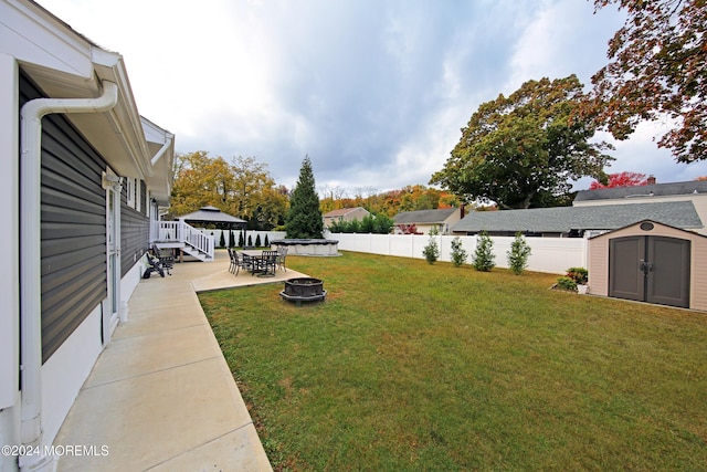 view of yard featuring a gazebo, an outdoor fire pit, a patio area, and a storage shed