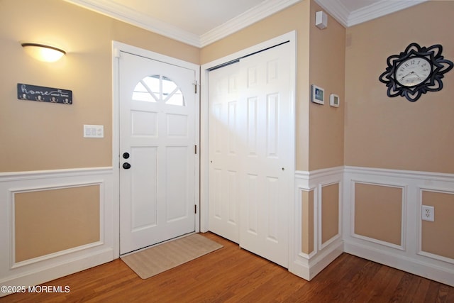 foyer entrance featuring hardwood / wood-style floors and ornamental molding