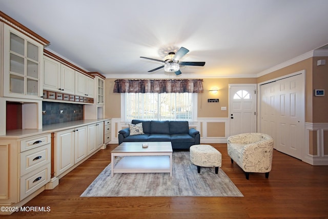 living room with hardwood / wood-style floors, ceiling fan, and crown molding