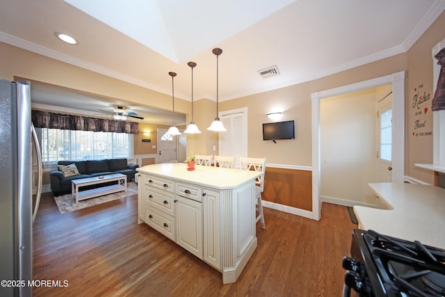 kitchen featuring gas range, dark wood-type flooring, a center island, stainless steel fridge, and ceiling fan