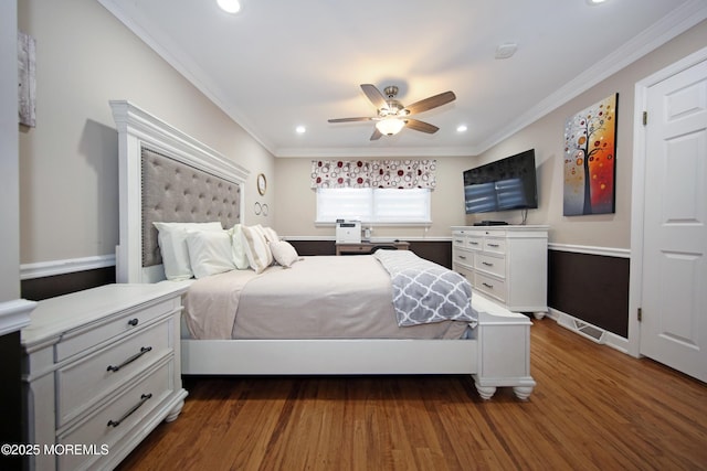 bedroom with dark hardwood / wood-style flooring, ceiling fan, and crown molding