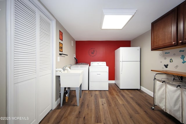 laundry room with sink, separate washer and dryer, cabinets, and dark hardwood / wood-style floors