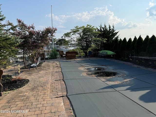 view of swimming pool featuring a patio area and fence