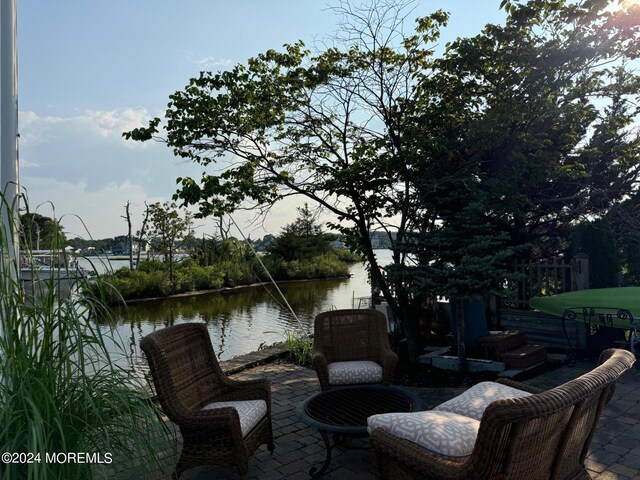 view of patio with a water view