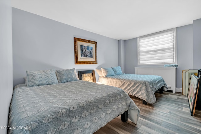 bedroom with hardwood / wood-style flooring