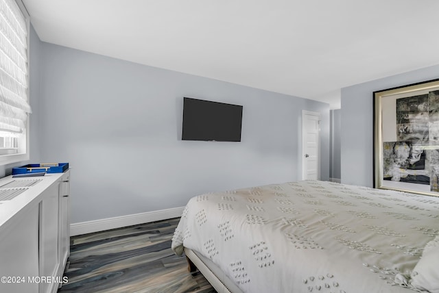 bedroom with dark wood-type flooring