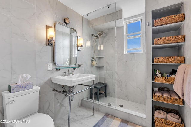 bathroom featuring tile walls, sink, a tile shower, and toilet