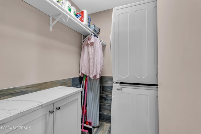 spacious closet featuring stacked washer / dryer