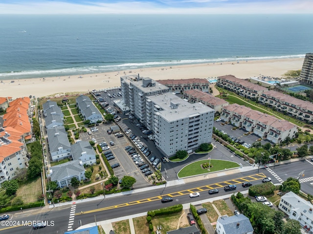 aerial view with a water view and a beach view