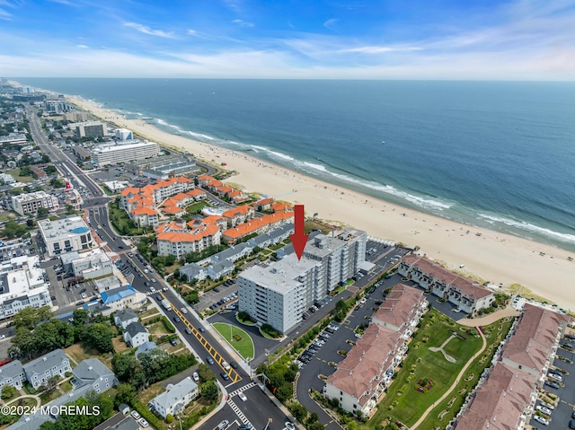 birds eye view of property with a beach view and a water view