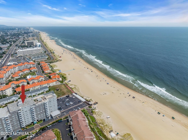 birds eye view of property with a beach view and a water view