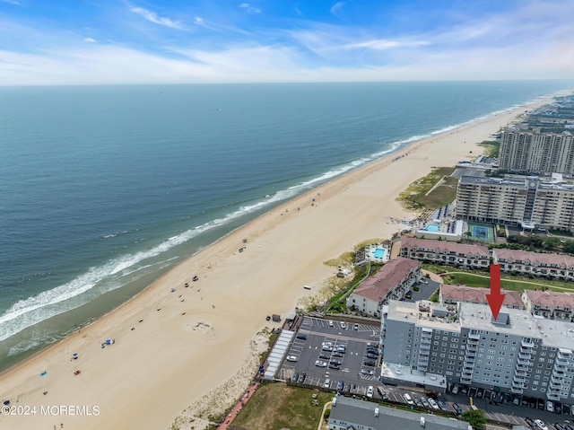 drone / aerial view with a water view and a view of the beach