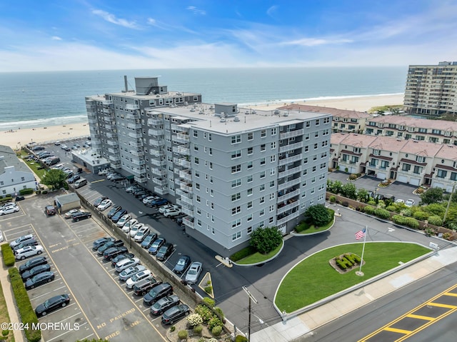 birds eye view of property featuring a water view and a view of the beach