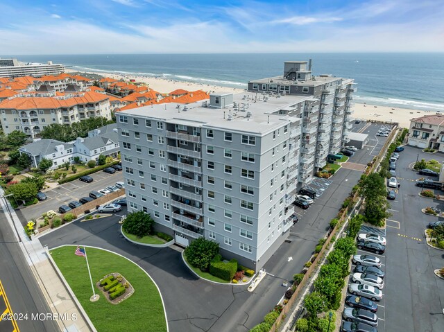 drone / aerial view with a water view and a view of the beach