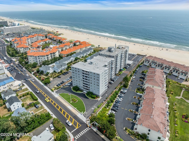 birds eye view of property with a water view and a view of the beach