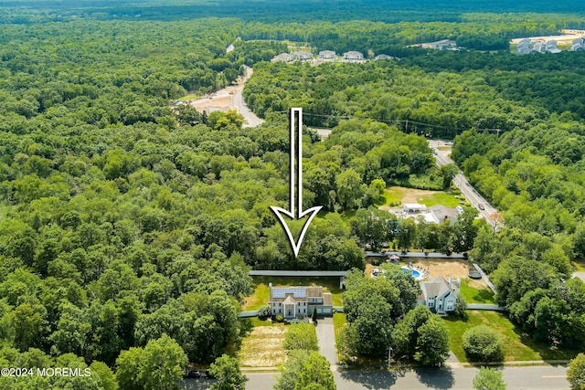 aerial view featuring a wooded view