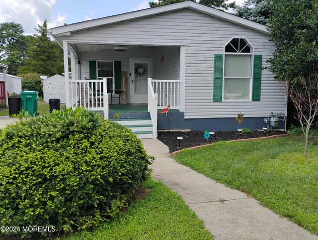 bungalow with a porch and a front yard