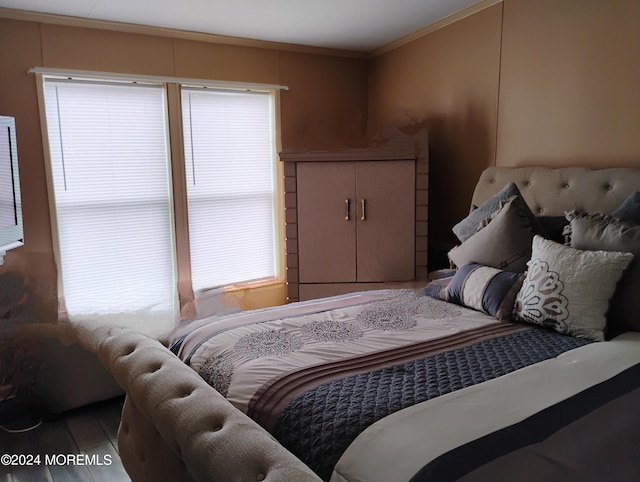 bedroom featuring hardwood / wood-style flooring and crown molding