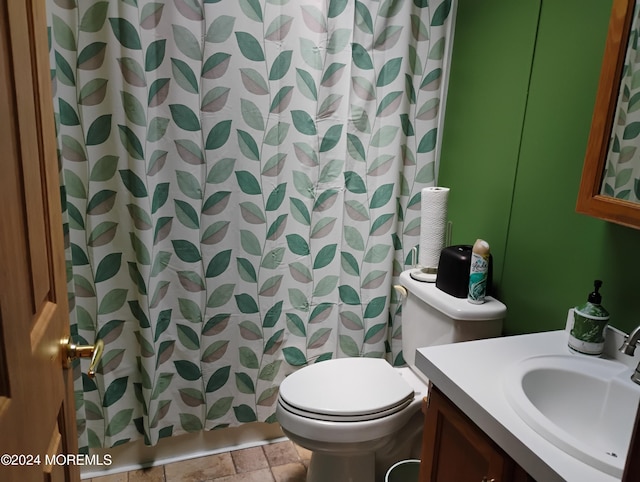 full bath with toilet, a shower with curtain, stone finish flooring, and vanity