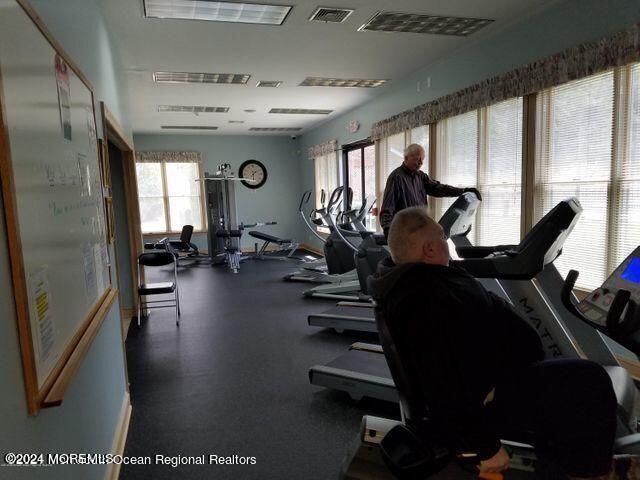 gym featuring a wealth of natural light and visible vents