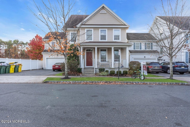 front facade with a garage and a porch