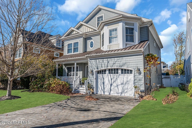 view of property featuring a porch, a garage, and a front lawn